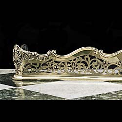 An Antique Rococo syle brass serpentine fender 