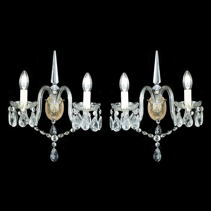 A twin branch pair of cut glass wall lights