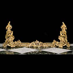 An antique French gilt bronze fireplace fender in the Rococo style 