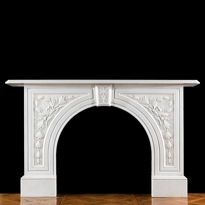 An antique Victorian arched marble fireplace surround 