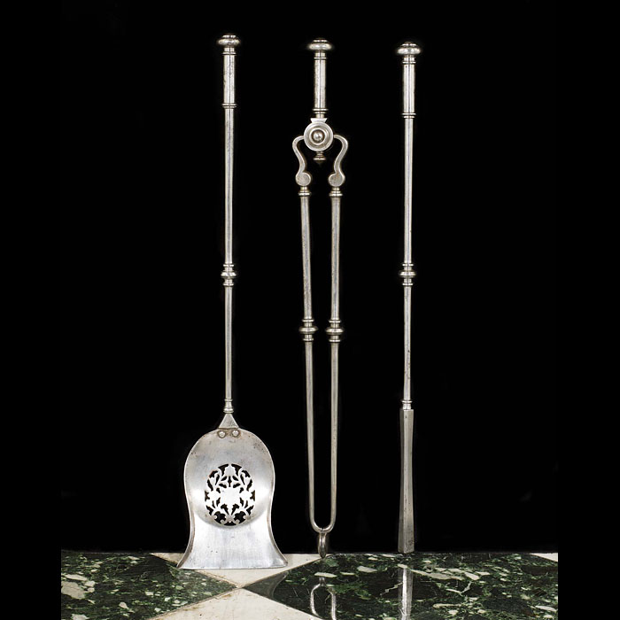 A set of Regency polished steel fire irons