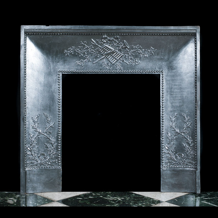 A cast iron French fireplace insert
