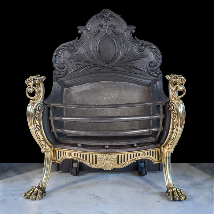 A Rococo style antique griffin fire basket