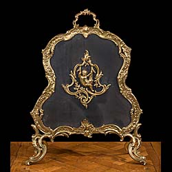 A Rococo style gilt brass fire screen