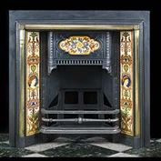 10831: A late Victorian cast iron Register Grate with inset tiled panels richly coloured with a floral arrangement on the single large shaped panel on the hood, the side tiles being arranged into Arabesques 